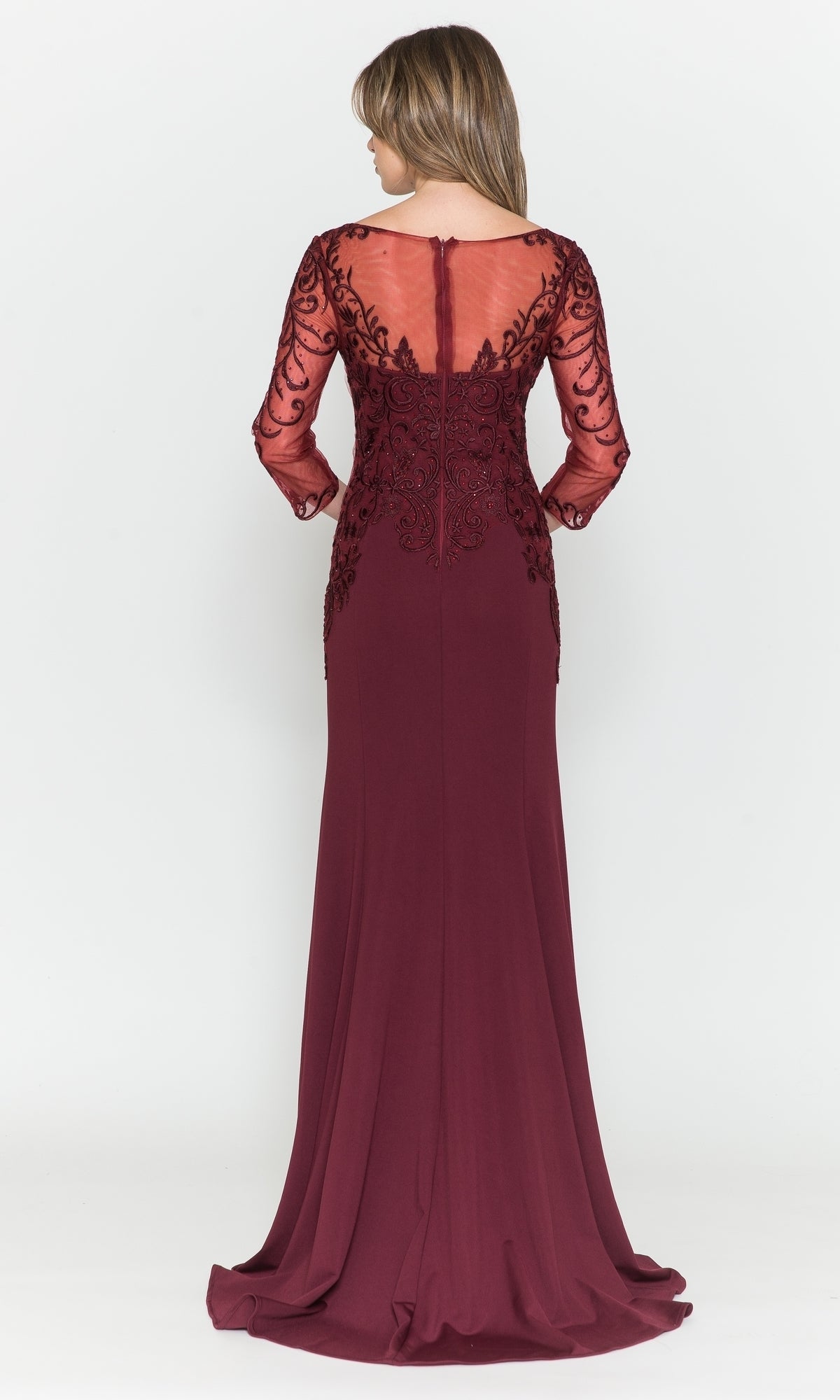 A woman models the Embroidered Sheer-Sleeved Long Prom Dress 8564, standing with her back to the camera and showcasing its sheer embroidered sleeves and back against a plain white background.